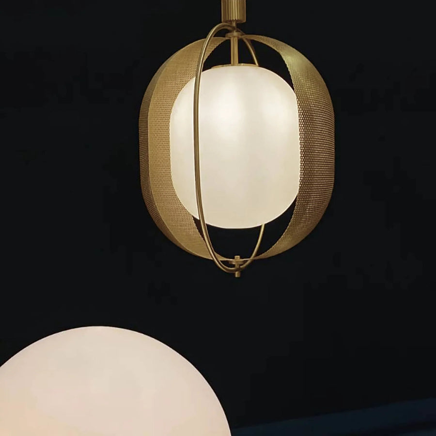 Pendant light with gold frame and white glass shade on a black background