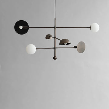 Modern Scandinavian minimal chandeliers with white spherical bulbs on a gray background from 101 Copenhagen available at Spacio retail stores in Mumbai & Kolkata. 