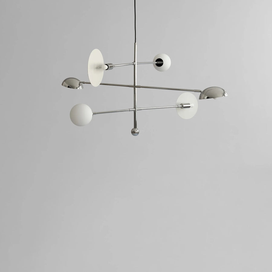 Modern chandelier with white glass shades on a gray background