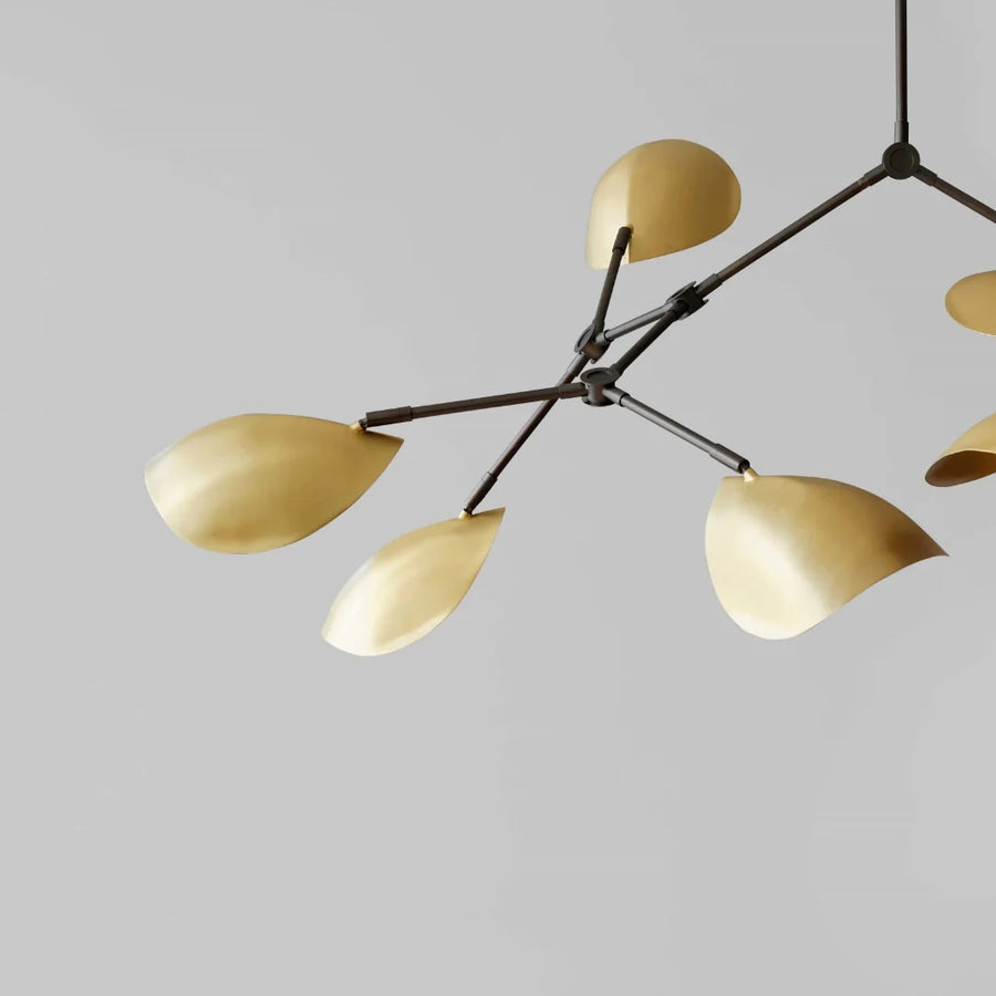 Modern chandelier with gold lampshades on a gray background