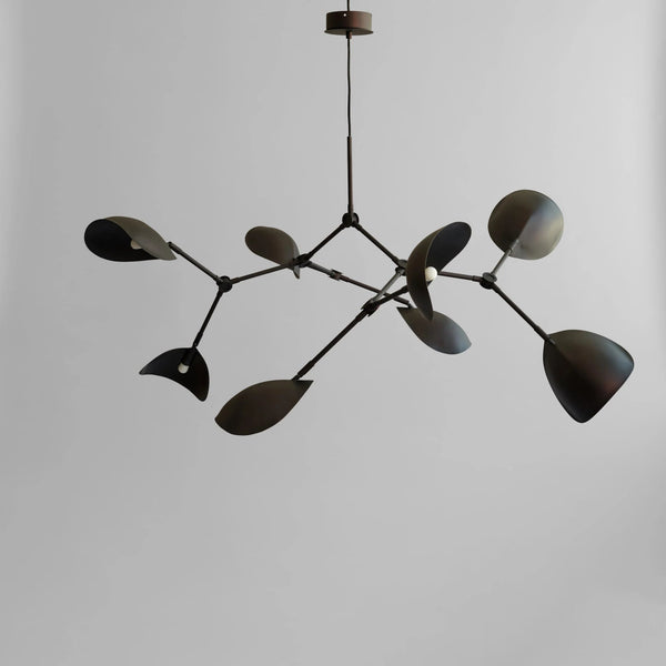Modern chandelier with black leaf-like design on a plain background in burned black finish available at Spacio retail stores in Mumbai & Kolkata. 