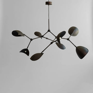 Modern chandelier with black leaf-like design on a plain background in burned black finish available at Spacio retail stores in Mumbai & Kolkata. 