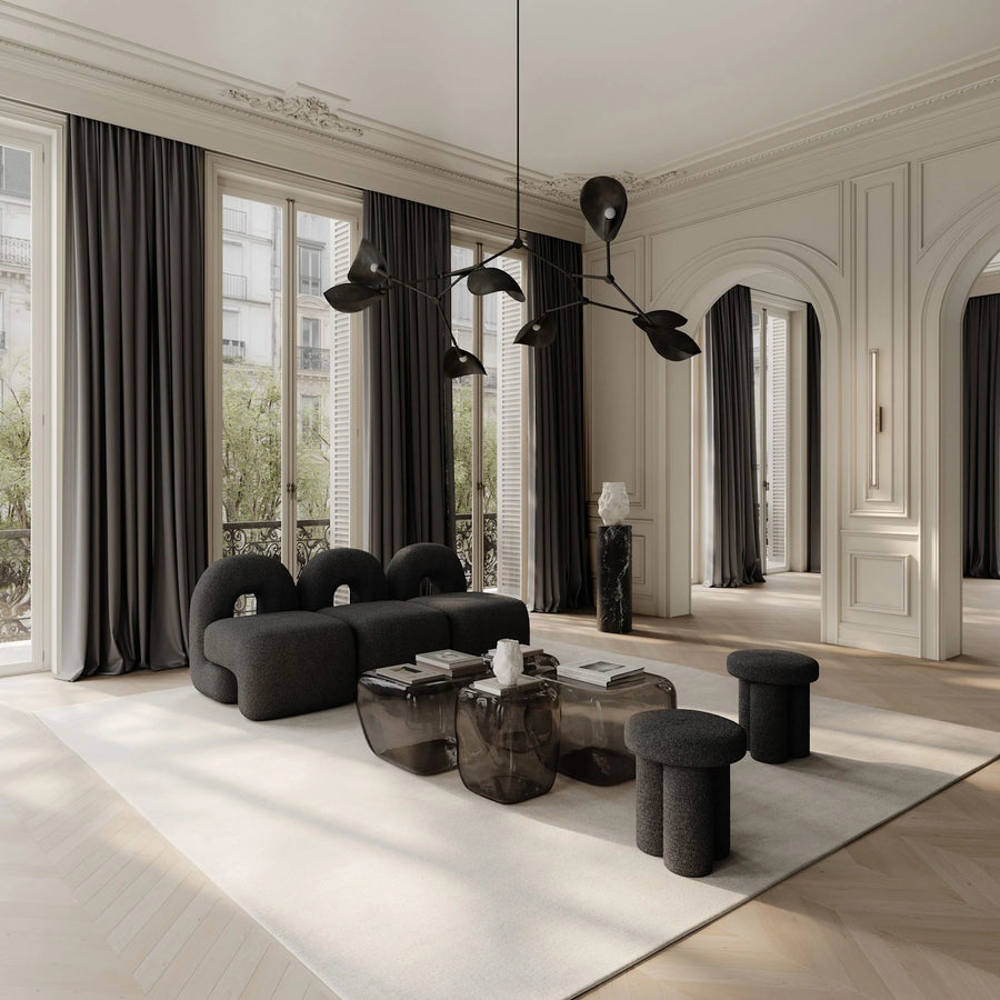 Modern living room with black furniture and large windows