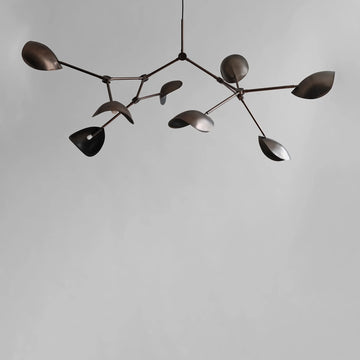 Modern chandelier with leaf-like design in bronze finish on a plain background from 101 Copenhagen available at Spacio retail stores in Mumbai & Kolkata. 