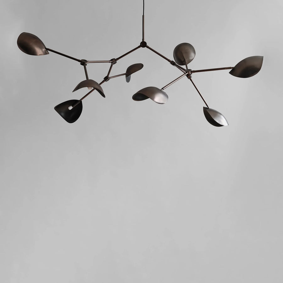 Modern chandelier with leaf-like design in bronze finish on a plain background from 101 Copenhagen available at Spacio retail stores in Mumbai & Kolkata. 