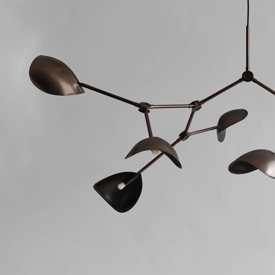 Modern chandelier with black and bronze design on a gray background