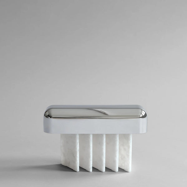 White minimal table lamp with metallic rim on a light gray background