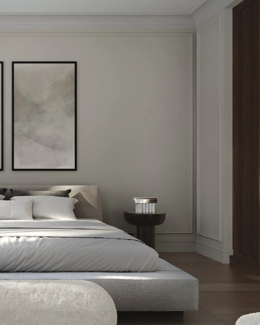 Modern bedroom with a bed, nightstand, and abstract art on the wall.