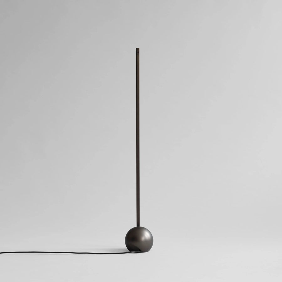Minimalist black pendant light on a gray background