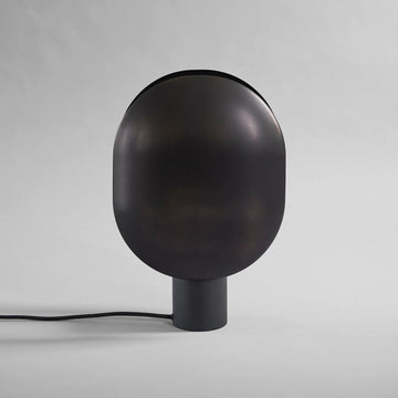 Black minimal design Japandi theme spherical lamp on a gray background from 101 Copenhagen available at Spacio retail stores in Mumbai & Kolkata.