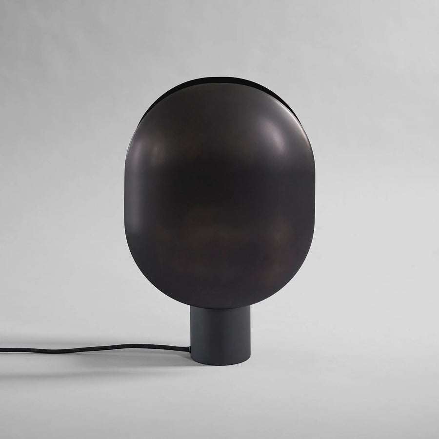 Black minimal design Japandi theme spherical lamp on a gray background from 101 Copenhagen available at Spacio retail stores in Mumbai & Kolkata.