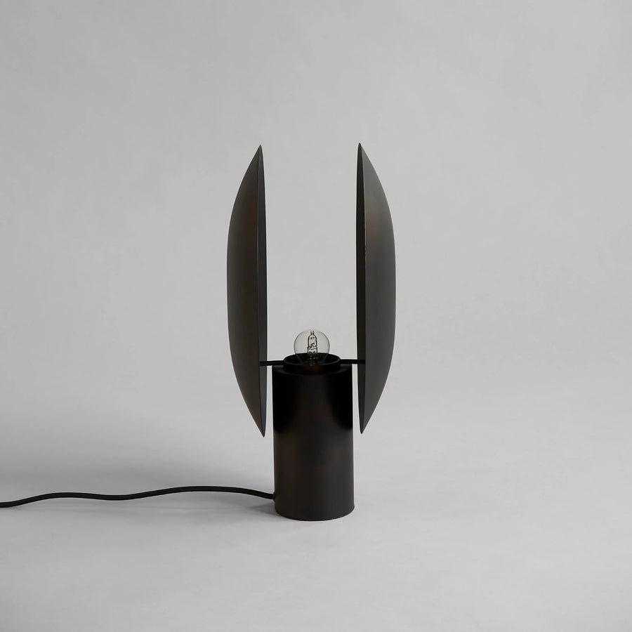 Modern black table lamp with unique design on a gray background