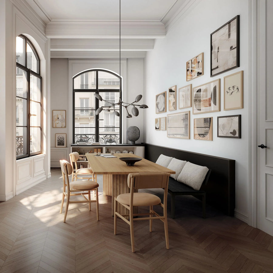 Modern dining room with wooden table and chairs, wall art, and large windows.