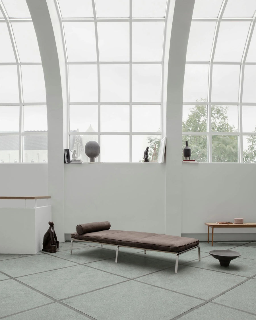 Modern lounge chair in a minimalistic room with large windows