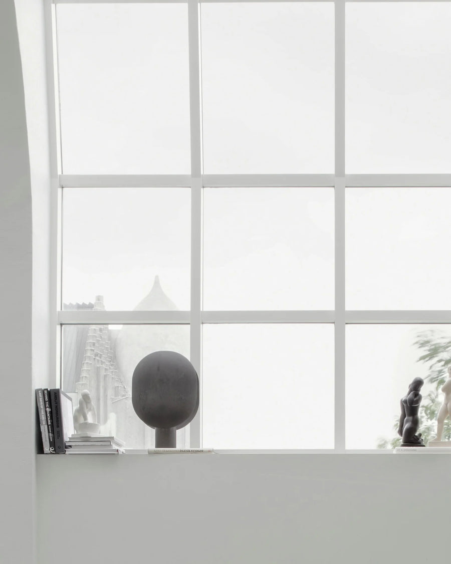 Window with grid pattern, interior decor, and blurred outdoor view