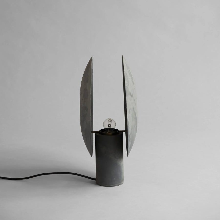 Modern black table lamp with unique design on a gray background