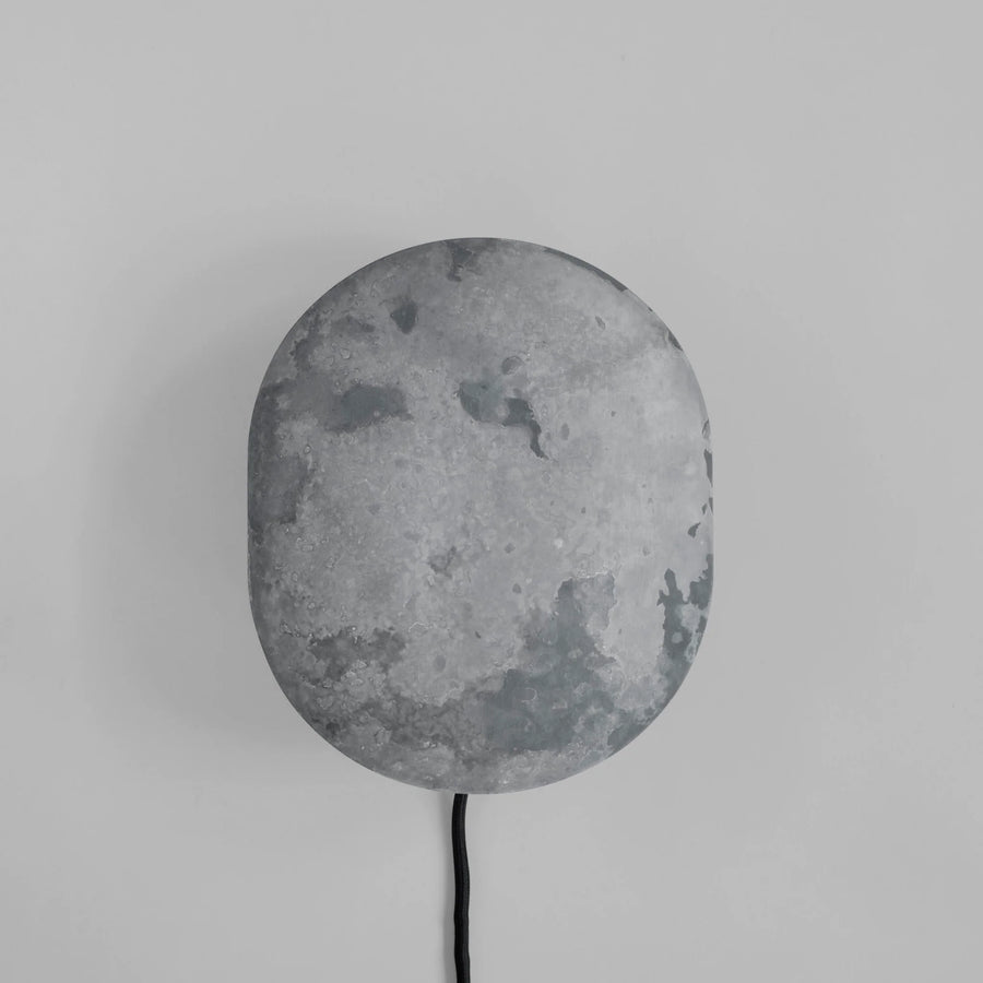 Clam Wall Light Oxidized by 101 Copenhagen on a light grey background available at Spacio retail stored in Mumbai & Kolkata. 