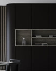 Modern interior with black cabinets and wooden shelves with a sculptural table lamp. 