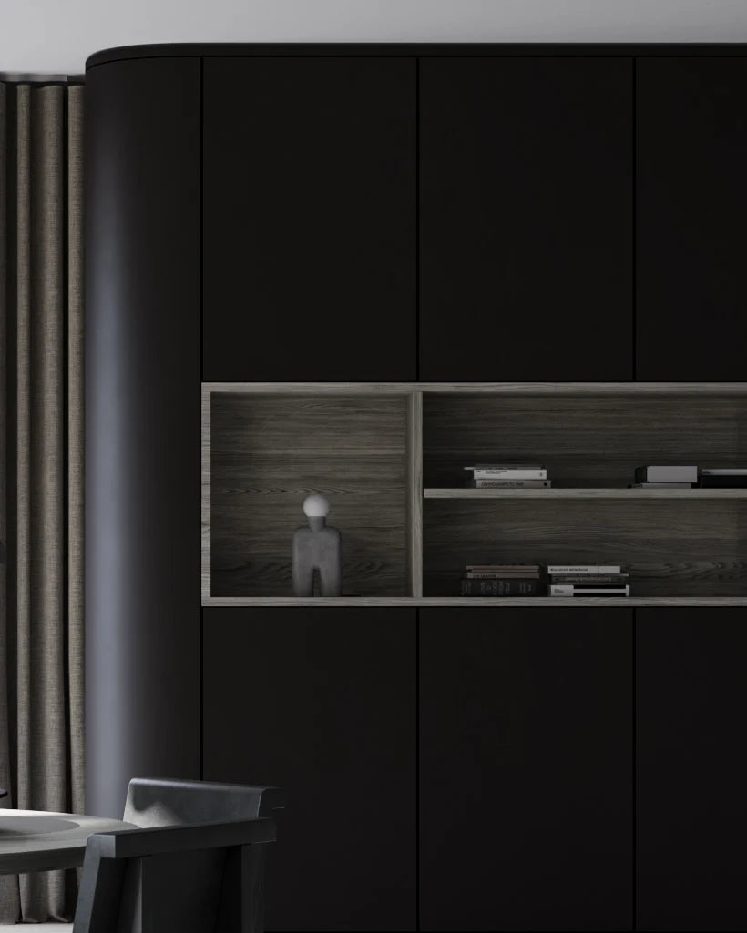 Modern interior with black cabinets and wooden shelves with a sculptural table lamp. 