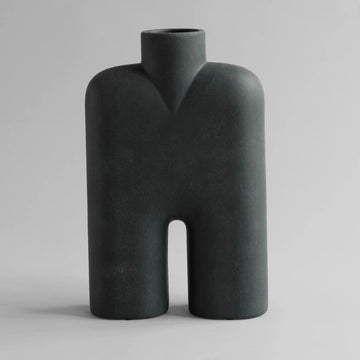 Dark gray abstract vase on a light gray background from 101 Copenhagen at Spacio retail stores in Mumbai & Kolkata. 