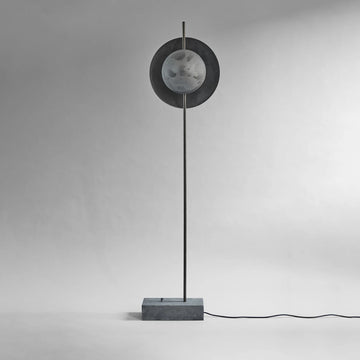 Modern floor lamp with circular design on a gray background