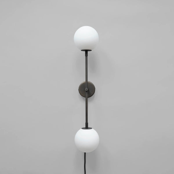 Wall-mounted lamp with two white spherical lights on a gray background
available at Spacio retail stores in Mumbai & Kolkata
