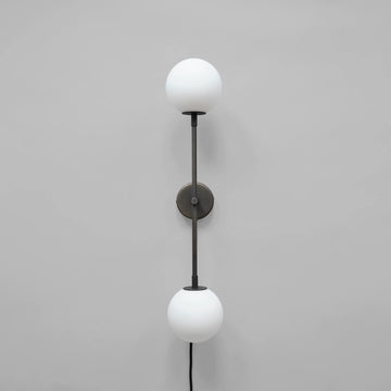 Wall-mounted lamp with two white spherical lights on a gray background
available at Spacio retail stores in Mumbai & Kolkata