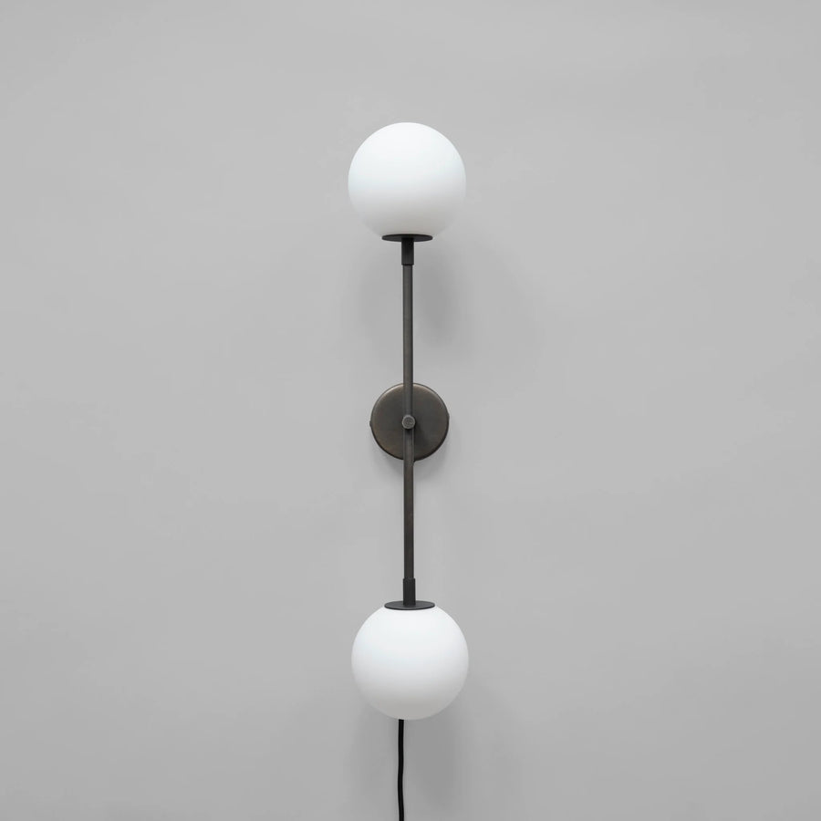 Wall-mounted lamp with two white spherical lights on a gray background
available at Spacio retail stores in Mumbai & Kolkata