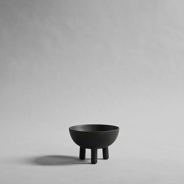 Coffee colour ceramic bowl on a gray background from 101 Copenhagen at Spacio retail stores in Mumbai & Kolkata. 