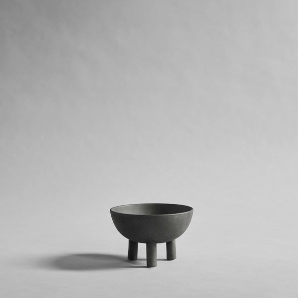 Dark Grey ceramic bowl on a gray background from 101 Copenhagen at Spacio retail stores in Mumbai & Kolkata. 