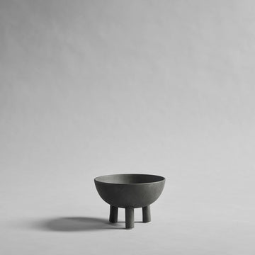 Dark Grey ceramic bowl on a gray background from 101 Copenhagen at Spacio retail stores in Mumbai & Kolkata. 