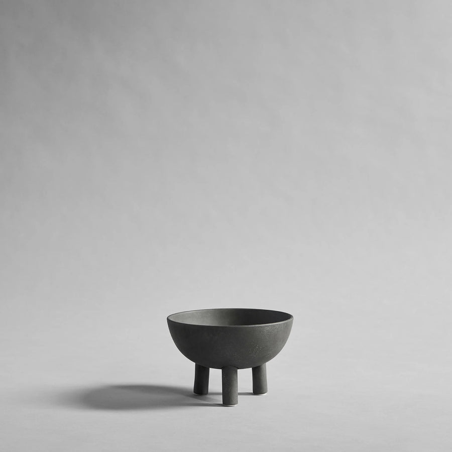 Dark Grey ceramic bowl on a gray background from 101 Copenhagen at Spacio retail stores in Mumbai & Kolkata. 
