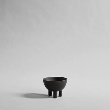 Coffee colour ceramic bowl on a gray background from 101 Copenhagen at Spacio retail stores in Mumbai & Kolkata. 