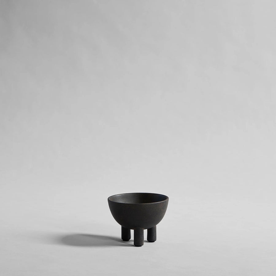Coffee colour ceramic bowl on a gray background from 101 Copenhagen at Spacio retail stores in Mumbai & Kolkata. 