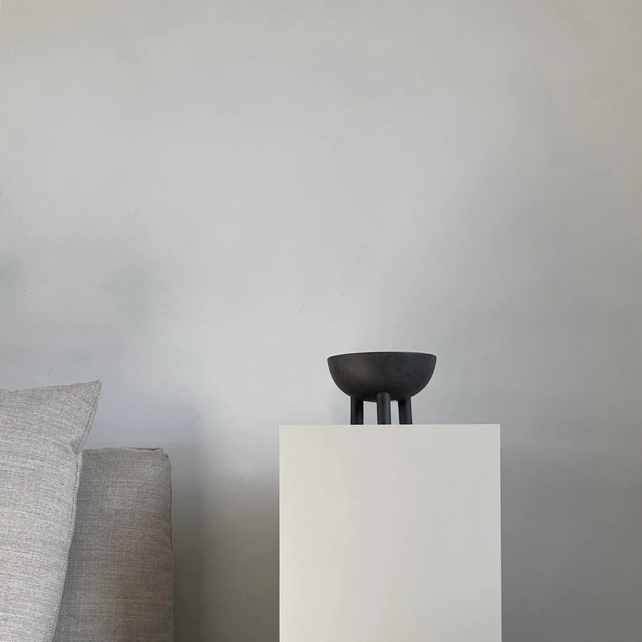 Coffee colour ceramic bowl on a white pedestal against a gray background from 101 Copenhagen at Spacio retail stores in Mumbai & Kolkata. 