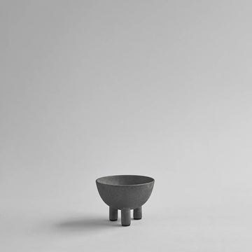 Dark grey ceramic bowl on a light gray background from 101 Copenhagen at Spacio retail stores in Mumbai & Kolkata. 