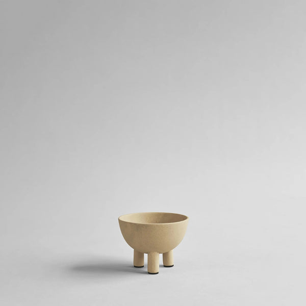 Beige ceramic bowl on a light gray background from 101 Copenhagen at Spacio retail stores in Mumbai & Kolkata. 