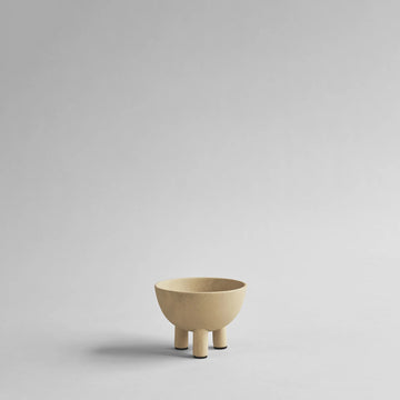 Beige ceramic bowl on a light gray background from 101 Copenhagen at Spacio retail stores in Mumbai & Kolkata. 