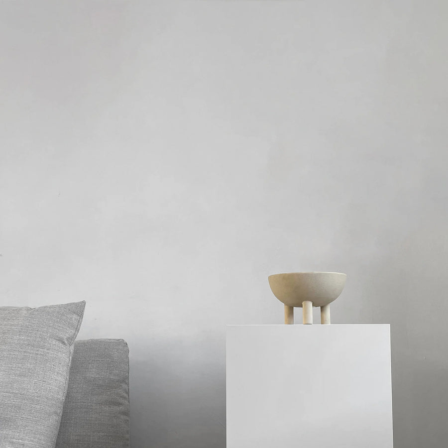 Small ceramic bowl on a white pedestal against a plain gray background from 101 Copenhagen at Spacio retail stores in Mumbai & Kolkata. 
