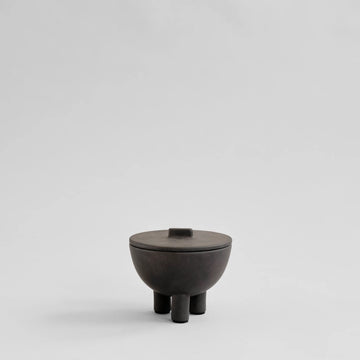 Coffee Colour ceramic bowl with lid on a light gray background from 101 Copenhagen at Spacio retail stores in Mumbai & Kolkata. 