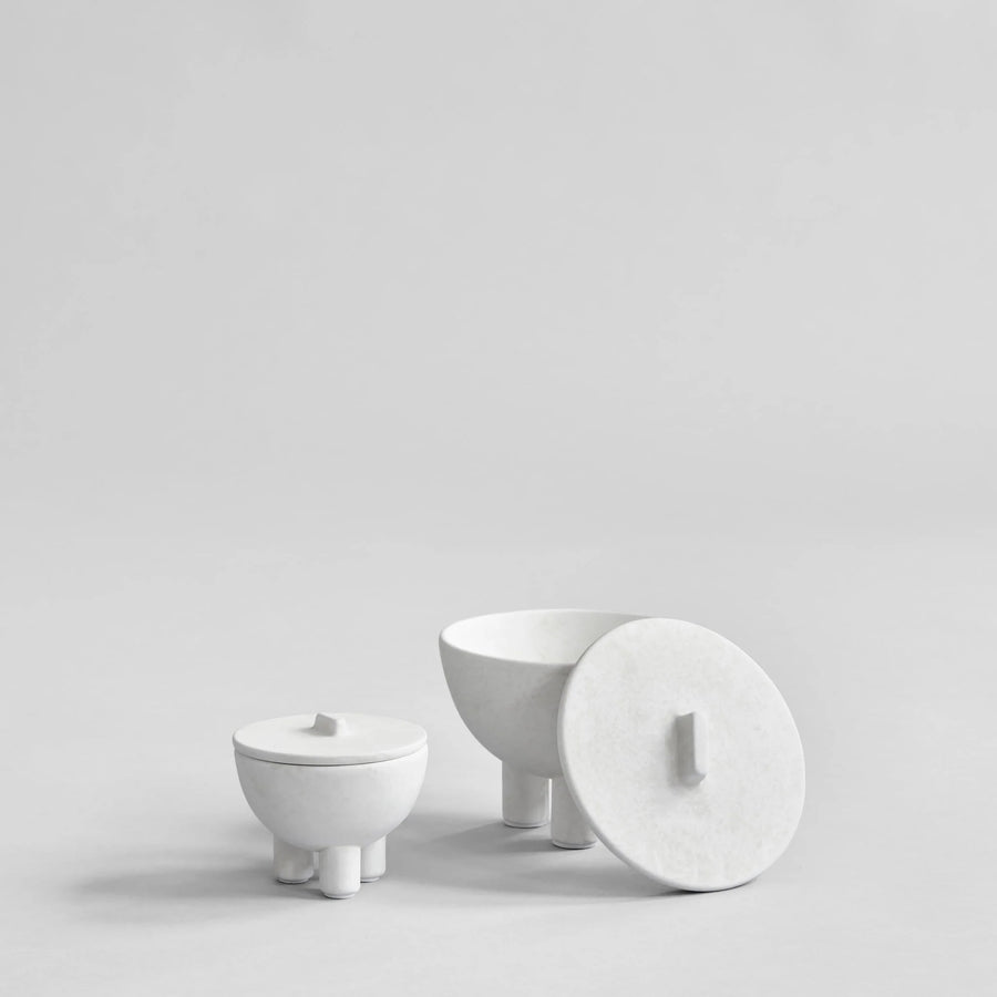 Set of white ceramic bowls on a light gray background from 101 Copenhagen at Spacio retail stores in Mumbai & Kolkata. 
