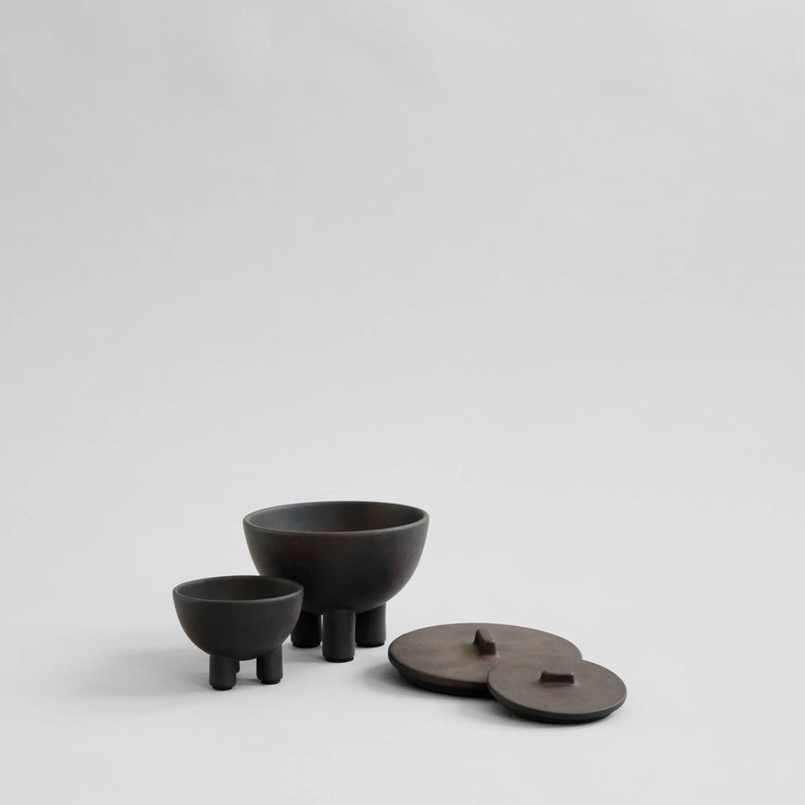 Set of Coffee colour ceramic bowls and lids on a light gray background from 101 Copenhagen at Spacio retail stores in Mumbai & Kolkata. 
