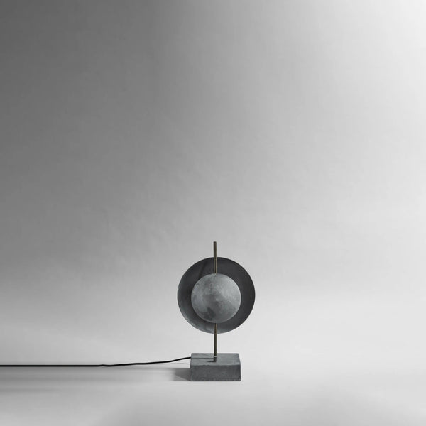 Modern & minimal Scandinavian table lamp with a spherical design on a gray background from 101 Copenhagen available at Spacio retail stores in Mumbai & Kolkata. 