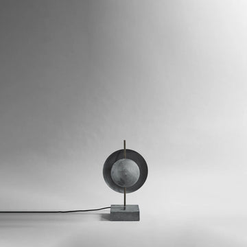 Modern & minimal Scandinavian table lamp with a spherical design on a gray background from 101 Copenhagen available at Spacio retail stores in Mumbai & Kolkata. 