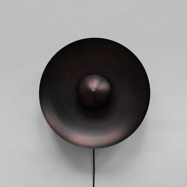 Dusk Wall Light Burned Black by 101 Copenhagen on a light grey background available at Spacio retail stores in Mumbai & Kolkata. 