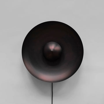 Dusk Wall Light Burned Black by 101 Copenhagen on a light grey background available at Spacio retail stores in Mumbai & Kolkata. 