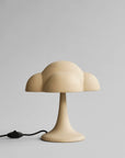 Beige table lamp with a cloud-like design on a gray background from 101 Copenhagen available at Spacio retail stores in Mumbai & Kolkata. 