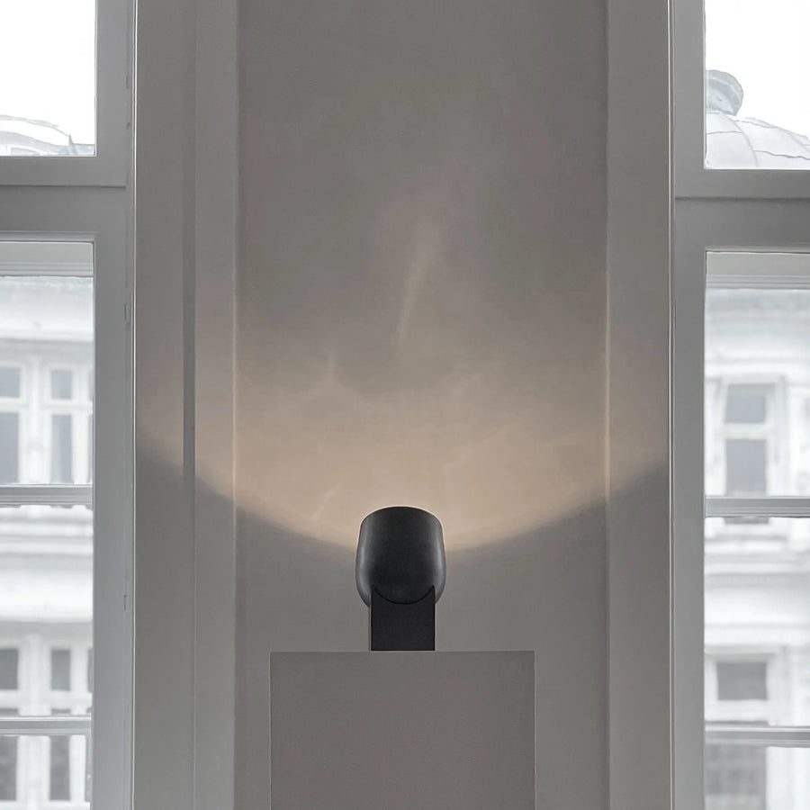 Modern minimal table lamp with a blurred cityscape background