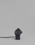 Modern black table lamp on a gray background