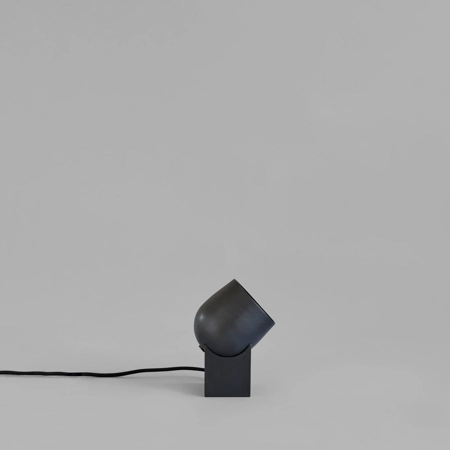 Modern black table lamp on a gray background